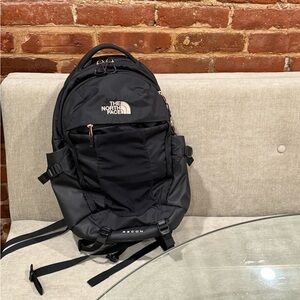 The North Face Black Recon Backpack rose gold accents